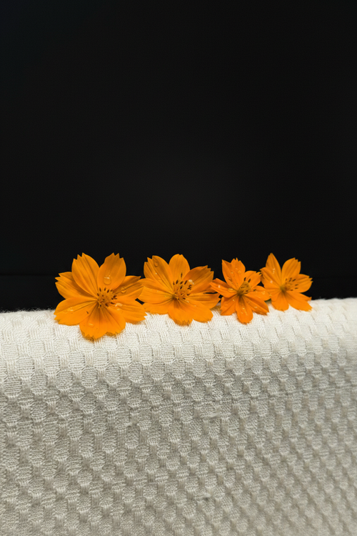 Orange flowers on towel with black background