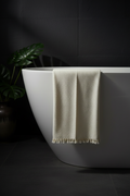 Towel on bathtub with dark moody background